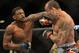 Dec 28, 2013; Las Vegas, NV, USA; Gleison Tibau (red gloves) and Michael Johnson (blue gloves) during their UFC Featherweight Bout at the MGM Grand Garden Arena. Johnson won the fight. Mandatory Credit: Jayne Kamin-Oncea-USA TODAY Sports