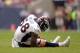 Dec 22, 2013; Houston, TX, USA; Denver Broncos outside linebacker Von Miller (58) grabs his right knee against the Houston Texans during the first half at Reliant Stadium. Mandatory Credit: Thomas Campbell-USA TODAY Sports