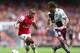 LONDON, ENGLAND - AUGUST 17: Theo Walcott of Arsenal avoids Antonio Luna of Aston Villa during the Barclays Premier League match between Arsenal and Aston Villa at Emirates Stadium on August 17, 2013 in London, England. (Photo by Clive Mason/Getty Images)