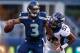 SEATTLE, WA - AUGUST 17: Quarterback Russell Wilson #3 of the Seattle Seahawks is tackled by linebacker Wesley Woodyard #52 of the Denver Broncos at CenturyLink Field on August 17, 2013 in Seattle, Washington. (Photo by Otto Greule Jr/Getty Images)