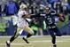 SEATTLE, WA - JANUARY 11: Quarterback Russell Wilson #3 of the Seattle Seahawks pushes back strong safety Roman Harper #41 of the New Orleans Saints in the fourth quarter while taking on the New Orleans Saints during the NFC Divisional Playoff Game at CenturyLink Field on January 11, 2014 in Seattle, Washington. (Photo by Otto Greule Jr/Getty Images)