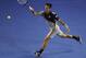 Novak Djokovic of Serbia reaches for a return to Denis Istomin of Uzbekistan during their third round match at the Australian Open tennis championship in Melbourne, Australia, Friday, Jan. 17, 2014.(AP Photo/Andrew Brownbill)