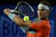 Rafael Nadal of Spain makes a backhand return to Thanasi Kokkinakis of Australia during their second round match at the Australian Open tennis championship in Melbourne, Australia, Thursday, Jan. 16, 2014.(AP Photo/Aaron Favila)