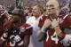 South Carolina wide receiver Nick Jones (3) and quarterback Connor Shaw (14) stand with coach Steve Spurrier, center, in front of the school band and listen to the alma mater after South Carolina defeated Wisconsin 34-24 in the Capital One Bowl NCAA college football game in Orlando, Fla., Wednesday, Jan. 1, 2014. (AP Photo/John Raoux)