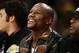 Boxer Floyd Mayweather Jr. watches an NBA basketball game between the Los Angeles Lakers and the Memphis Grizzlies on Friday, Nov. 15, 2013, in Los Angeles. (AP Photo/Jae C. Hong)