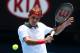 MELBOURNE, AUSTRALIA - JANUARY 18: Roger Federer of Switzerland plays a backhand in his third round match against Teymuraz Gabashvili of Russia during day six of the 2014 Australian Open at Melbourne Park on January 18, 2014 in Melbourne, Australia. (Photo by Cassie Trotter/Getty Images)
