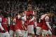 Arsenal's Santi Cazorla, center, celebrates scoring his side's first goal with his teammates during the English Premier League soccer match between Arsenal and Fulham at the Emirates Stadium in London, Saturday, Jan. 18, 2014. (AP Photo/Matt Dunham)