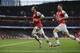 Arsenal's Santi Cazorla, left, celebrates scoring his side's first goal with teammate Olivier Giroud during the English Premier League soccer match between Arsenal and Fulham at the Emirates Stadium in London, Saturday, Jan. 18, 2014. (AP Photo/Matt Dunham)