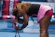 Serena Williams of the U.S. supports herself with a racket as she plays Ana Ivanovic of Serbia during their fourth round match at the Australian Open tennis championship in Melbourne, Australia, Sunday, Jan. 19, 2014.(AP Photo/Aaron Favila)