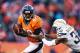 DENVER, CO - JANUARY 12: Julius Thomas #80 of the Denver Broncos tries to avoid the tackle of Marcus Gilchrist #38 of the San Diego Chargers during the AFC Divisional Playoff Game at Sports Authority Field at Mile High on January 12, 2014 in Denver, Colorado. (Photo by Christian Petersen/Getty Images)