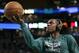 Boston Celtics guard Rajon Rondo wears headphones as he drives to the basket during a practice before an NBA basketball game against the Los Angeles Lakers, in Boston, Friday, Jan. 17, 2014. Celtics head coach Brad Stevens and general manager Danny Ainge both said Rondo would return for the game