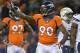 Denver Broncos defensive end Shaun Phillips (90) motions to teammates against the San Diego Chargers in the fourth quarter of an NFL AFC division playoff football game, Sunday, Jan. 12, 2014, in Denver. (AP Photo/Jack Dempsey)