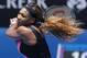 Serena Williams of the U.S. follows through on a shot to Ana Ivanovic of Serbia during their fourth round match at the Australian Open tennis championship in Melbourne, Australia, Sunday, Jan. 19, 2014.(AP Photo/Eugene Hoshiko)