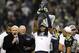 Jan 19, 2014; Seattle, WA, USA; Seattle Seahawks cornerback Richard Sherman hoists the George Halas Trophy after the 2013 NFC Championship football game against the San Francisco 49ers at CenturyLink Field. Mandatory Credit: Joe Nicholson-USA TODAY Sports