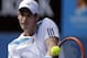 Andy Murray of Britain makes a backhand return to Stephane Robert of France during their fourth round match at the Australian Open tennis championship in Melbourne, Australia, Monday, Jan. 20, 2014.(AP Photo/Rick Rycroft)