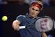 Roger Federer of Switzerland makes a backhand return during his fourth round match against Jo-Wilfried Tsonga of France at the Australian Open tennis championship in Melbourne, Australia, Monday, Jan. 20, 2014.(AP Photo/Andrew Brownbill)