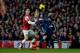 Arsenal's Laurent Koscielny competes for the ball with Fulham's Dimitar Berbatov, right, during the English Premier League soccer match between Arsenal and Fulham at the Emirates Stadium in London, Saturday, Jan. 18, 2014. (AP Photo/Matt Dunham)