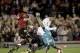 Argentina's Newell's Old Boys' goalkeeper Nahuel Guzman blocks a shot by Brazil's Atletico Mineiro's Bernard as Santiago Vergini, left, looks on at left during a Copa Libertadores first leg semifinal soccer match between Argentina's Newell's Old Boys and Brazil's Atletico Mineiro in Rosario, Argentina, Wednesday, July 3, 2013. (AP Photo/Eduardo Di Baia)