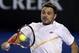 Stanislas Wawrinka of Switzerland makes a backhand return to Tommy Robredo of Spain during their fourth round match at the Australian Open tennis championship in Melbourne, Australia, Sunday, Jan. 19, 2014. (AP Photo/Rick Rycroft)