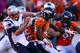 DENVER, CO - JANUARY 19: Tom Brady #12 of the New England Patriots in action against the Denver Broncos during the AFC Championship game at Sports Authority Field at Mile High on January 19, 2014 in Denver, Colorado. (Photo by Doug Pensinger/Getty Images)