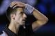 Novak Djokovic of Serbia reacts to a lost point against Stanislas Wawrinka of Switzerland during their quarterfinal at the Australian Open tennis championship in Melbourne, Australia, Tuesday, Jan. 21, 2014.(AP Photo/Rick Rycroft)