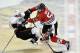 Chicago Blackhawks left wing Brandon Bollig, right, takes out Anaheim Ducks defenseman Ben Lovejoy during the third period of an NHL hockey game Friday, Dec. 6, 2013, in Chicago. The Ducks won 3-2 in a shootout. (AP Photo/Brian Kersey)