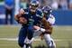 SEATTLE, WA - AUGUST 17: Quarterback Russell Wilson #3 of the Seattle Seahawks is tackled by linebacker Wesley Woodyard #52 of the Denver Broncos at CenturyLink Field on August 17, 2013 in Seattle, Washington. (Photo by Otto Greule Jr/Getty Images)