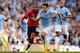 MANCHESTER, ENGLAND - SEPTEMBER 22: Jesus Navas of Manchester City is chased by Ashley Young of Manchester United during the Barclays Premier League match between Manchester City and Manchester United at the Etihad Stadium on September 22, 2013 in Manchester, England. (Photo by Michael Regan/Getty Images)