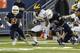 Bellevue running back Budda Baker (32) avoids a tackle from Eastside Catholic's Jonathan Webster, right, in the second half of the Class 3A high school football championship, Friday, Dec. 6, 2013, in Tacoma, Wash. Bellevue beat Eastside Catholic 52-20. (AP Photo/Ted S. Warren)