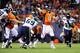 Aug 18, 2012; Denver, CO, USA; Denver Broncos quarterback Peyton Manning (18) passes in the second quarter against the Seattle Seahawks at Sports Authority Field. Mandatory Credit: Byron Hetzler-USA TODAY Sports