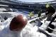 A football with the Super Bowl XLVIII logo is set on a mound of snow as an for an NFL photographer to make photos of it as workers shovel snow off the seating area at MetLife Stadium as crews removed snow ahead of Super Bowl XLVIII following a snow storm, Wednesday, Jan. 22, 2014, in East Rutherford, N.J. Super Bowl XLVIII, which will be played between the Denver Broncos and the Seattle Seahawks on Feb. 2, will be the first NFL title game held outdoors in a city where it snows. (AP Photo/Julio Cortez)