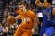 Phoenix Suns shooting guard Goran Dragic (1) drrives on Dallas Mavericks point guard Shane Larkin (3) in the fourth quarter during an NBA basketball game, Friday, Jan. 17, 2014, in Phoenix. (AP Photo/Rick Scuteri)