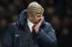Arsenal's manager Arsene Wenger wipe his face as he walks from the pitch after his team's 1-0 loss at Manchester United in their English Premier League soccer match at Old Trafford Stadium, Manchester, England, Saturday Nov. 10, 2013. (AP Photo/Jon Super)