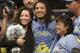 Benson Henderson, center, celebrates with his finacee, Maria Magana, left, and his mother, Song Henderson, after defeating Gilbert Melendez in a UFC lightweight championship mixed martial arts fight in San Jose, Calif., Saturday, April 20, 2013. Henderson won by split decision to retain the championship. (AP Photo/Jeff Chiu)