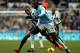 Newcastle United's Loic Remy, left, puts pressure on Manchester City's Yaya Toure, right, during their English Premier League soccer match at St James' Park, Newcastle, England, Sunday, Jan. 12, 2014. (AP Photo/Scott Heppell)