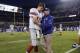 New York Giants coach Tom Coughlin talks to quarterback Eli Manning before the Giants' NFL football game against the Chicago Bears, Thursday, Oct. 10, 2013, in Chicago. (AP Photo/Nam Y. Huh)
