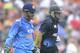 India’s MS Dhoni, left, and New Zealand's Ross Taylor run from the ground as rain interrupts play in the second one-day International cricket match at Seddon Park in Hamilton, New Zealand, Wednesday, Jan. 22, 2014. (AP Photo/SNPA, Ross Setford) NEW ZEALAND OUT