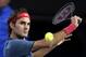 Roger Federer of Switzerland makes a backhand return to Rafael Nadal of Spain during their semifinal at the Australian Open tennis championship in Melbourne, Australia, Friday, Jan. 24, 2014.(AP Photo/Rick Rycroft)