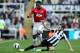 Manchester United's Antonio Valencia, left, vies for the ball with Newcastle United's Yohan Cabaye, right, during their English Premier League soccer match at the Sports Direct Arena, Newcastle, England, Sunday, Oct. 7, 2012. (AP Photo/Scott Heppell)