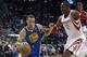 Golden State Warriors' Stephen Curry (30) drives around Houston Rockets' Dwight Howard (12) during the first quarter of an NBA basketball game Friday, Dec. 6, 2013, in Houston. (AP Photo/David J. Phillip)