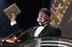 Wrestler Hulk Hogan holds up a plaque while speaking after being inducted into the WWE Hall of Fame in Los Angeles on Saturday, April 2, 2005. (AP Photo/Matt Sayles)