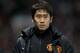 FILE - In this Wednesday Jan. 1, 2014 file photo, Manchester United's Shinji Kagawa heads for the substitutes bench before his team's English Premier League soccer match against Tottenham at Old Trafford Stadium, Manchester, England. Kagawa has started just seven of Manchester United’s 21 league games so far this season, a struggle that has been well-documented in both Europe and Asia, but the playmaker is almost certain to be in the starting lineup for Japan in its opening World Cup match against Ivory Coast on June 14. (AP Photo/Jon Super)