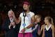 Li Na of China speaks after defeating Dominika Cibulkova of Slovakia, right, in their women's singles final at the Australian Open tennis championship in Melbourne, Australia, Saturday, Jan. 25, 2014. (AP Photo/Aaron Favila)