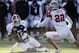 North quarterback Tajh Boyd (10), of Clemson, slides in front of the would be tackle from South line backer Telvin Smith (22), of Florida State, during the first half of the Senior Bowl NCAA college football game on Saturday, Jan. 25, 2014, in Mobile, Ala. (AP Photo/Butch Dill)