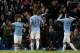 Manchester City's Sergio Aguero, left, celebrates with teammates after scoring the third of his 3 goals past Watford's goalkeeper Jonathan Bond during their English FA Cup fourth round soccer match at The City of Manchester Stadium, Manchester, England, Saturday, Jan. 25, 2014. (AP Photo/Jon Super)