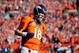 DENVER, CO - JANUARY 19: Peyton Manning #18 of the Denver Broncos runs off the field against the New England Patriots during the AFC Championship game at Sports Authority Field at Mile High on January 19, 2014 in Denver, Colorado. (Photo by Kevin C. Cox/Getty Images)