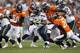 Seattle Seahawks runningback Marshawn Lynch, center, runs for yardage against the Denver Broncos in the first half of an NFL football preseason game, Saturday, Aug. 18, 2012, in Denver. (AP Photo/David Zalubowski)