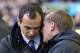 Liverpool's manager Brendan Rodgers, right, whispers to Everton's manager Roberto Martinez before their English Premier League soccer match at Goodison Park Stadium, Liverpool, England, Saturday Nov. 23, 2013. (AP Photo/Jon Super)