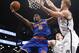 New York Knicks guard Tim Hardaway Jr. (5) goes up for a layup against the defense of Brooklyn Nets forward Mason Plumlee (1) in the second half of their NBA basketball game at the Barclays Center, Thursday, Dec. 5, 2013, in New York. Hardaway scored 12 points as the Knicks defeated the Nets 113-83. (AP Photo/Kathy Willens)