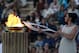 Actress Ino Menegaki, playing the role of high priestess, lights the torch with the Olympic Flame during a handover ceremony in Athens' Panathinaiko Stadium, on Saturday, Oct. 5, 2013. The Olympic flame has been handed to organizers of the Sochi Winter Olympics in a ceremony at the site of the first modern summer games. After a seven-day run through Greece, the flame will cover 40,000 miles on Russian soil. The record-setting relay will start on Monday in Moscow and finish in Sochi on Feb. 7, the opening day of the games. (AP Photo/Kostas Tsironis)